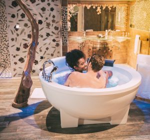 Happy young interracial couple relaxed enjoying their self in the jacuzzi